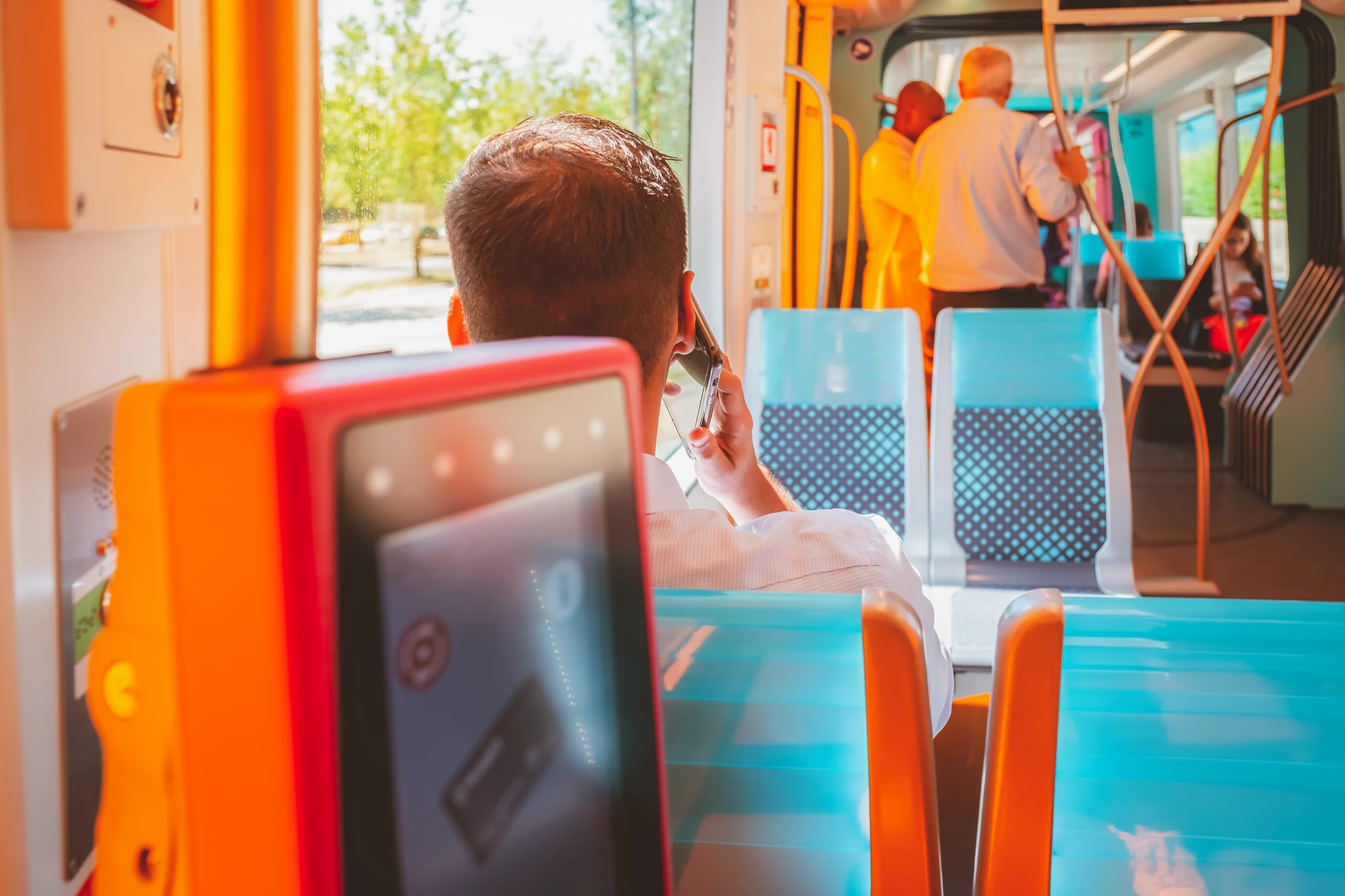 A man talking on the phone in a tram in Luxembourg City