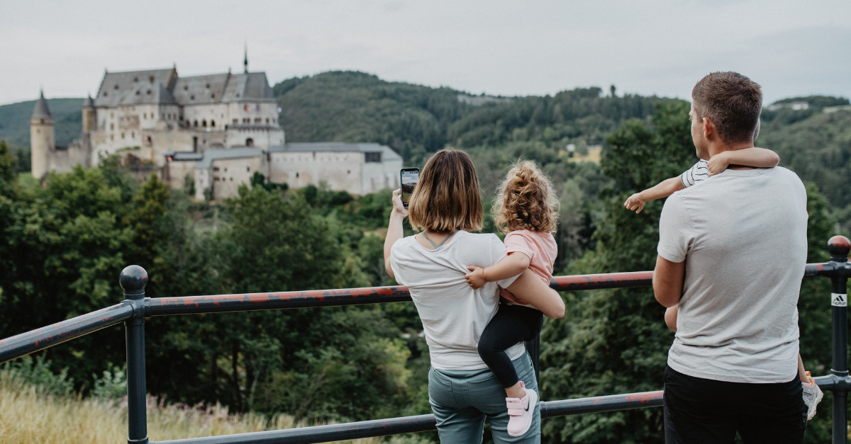A family of four taking a picture overlooking Vianden Castle