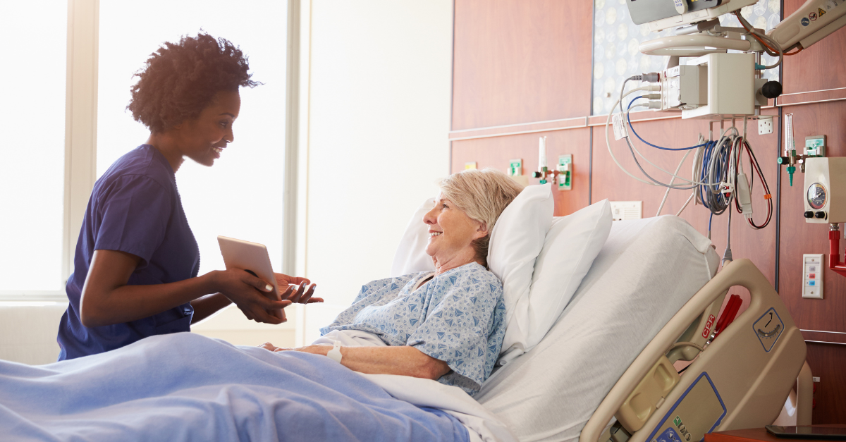 Nurse caring for a patient in a hospital bed
